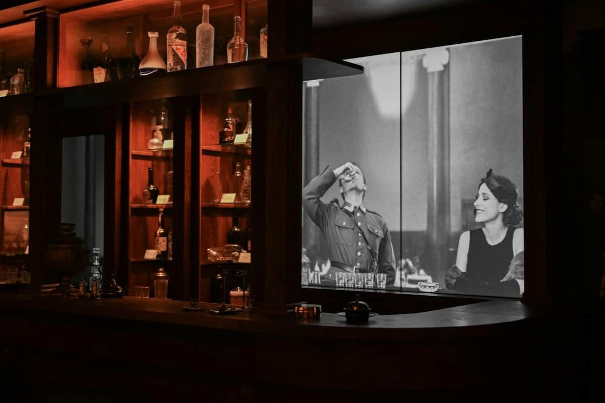 Liquor shelf and screen with projected movie.