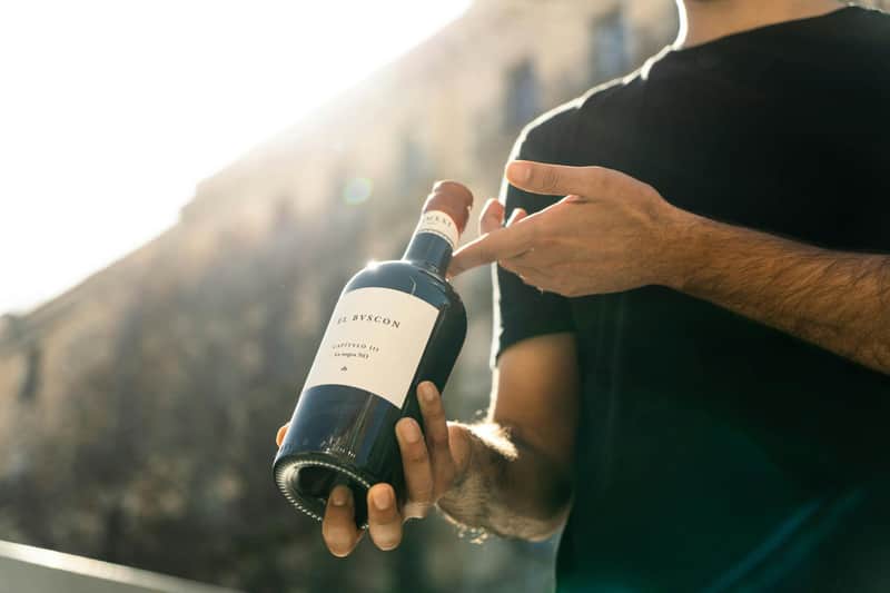 Barcelona: Small-Group Guided Food & Wine Tour A man holding a bottle of red wine.